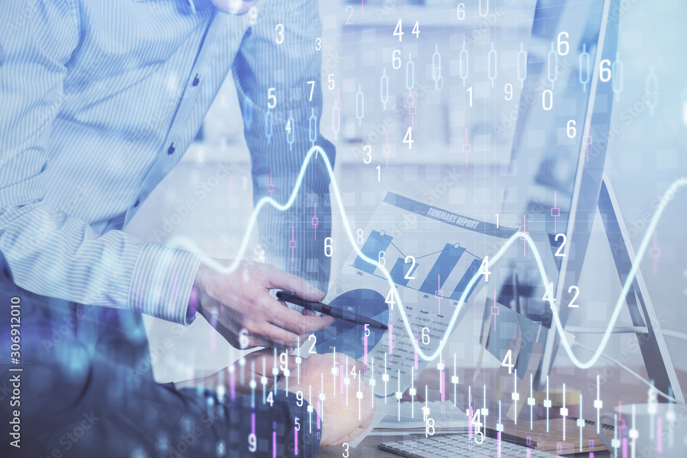 Double exposure of chart with businessman typing on computer in office on background. Concept of hard work. Double exposure of chart with businessman typing on computer in office on background. Concept of hard work.