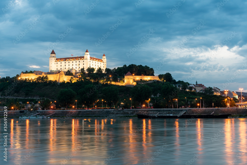 Beautiful view of Bratislava Castle on the banks of the Danube at night during the blue hour in Bratislava, Slovakia