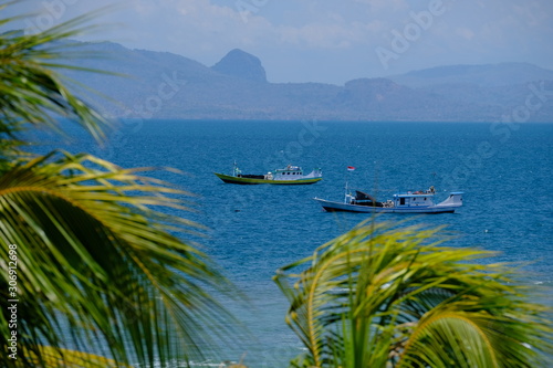 Indonesia Kupang traditional fishing boats lie at anchor photo