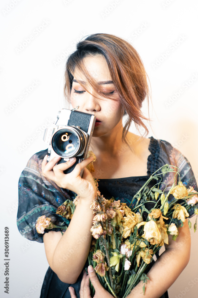 Young asian women photographer with camera on isolated background