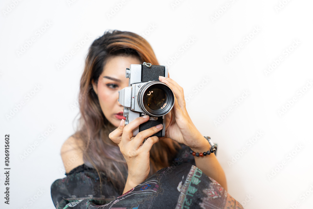 Young asian women photographer smiling and happy with vintage camera on isolated background Young asian women photographer smiling and happy with vintage camera on isolated background