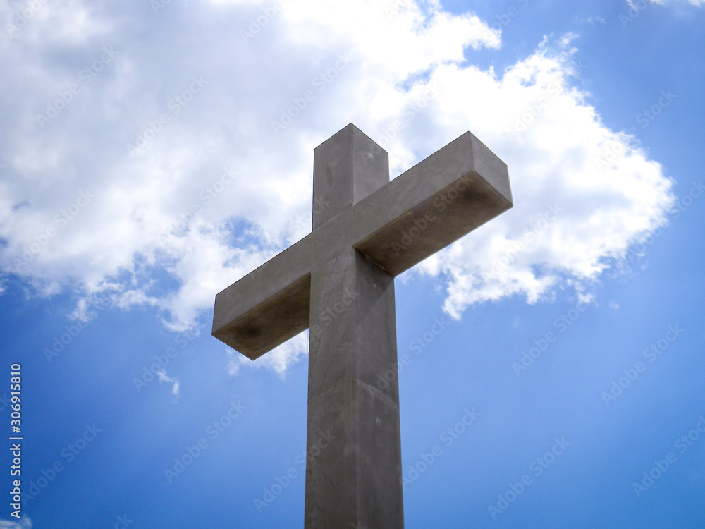 Isolated cross image with blue sky background.