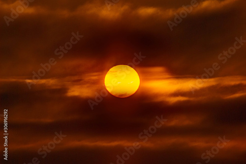 Fiery colored sunset in cloudy sky