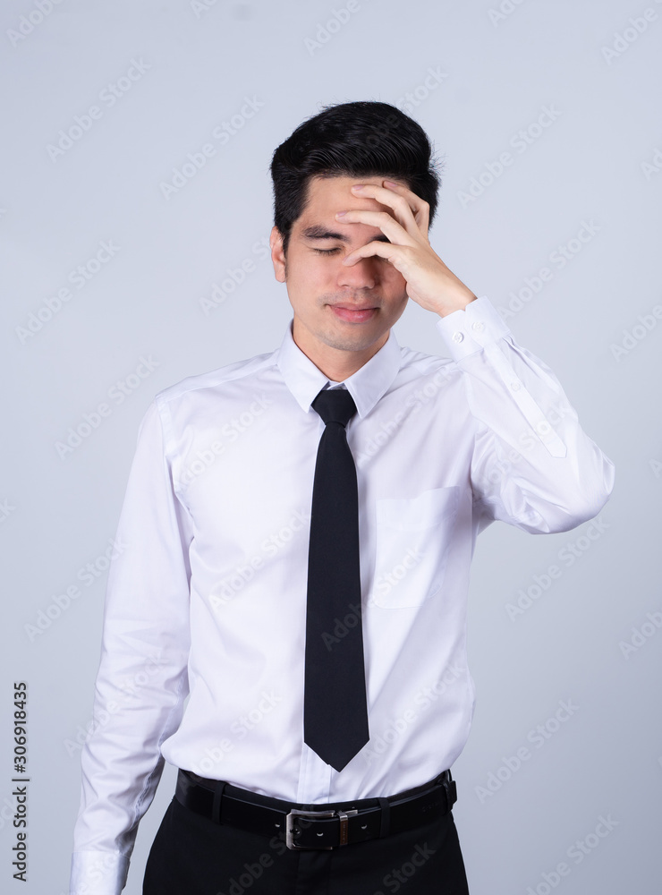Portrait handsome young asian .businessman wearing a white shirt excitement or celebrating his victory sign isolated on grey background in studio. Asian man people. business success concept. Portrait handsome young asian .businessman wearing a white shirt excitement or celebrating his victory sign isolated on grey background in studio. Asian man people. business success concept.