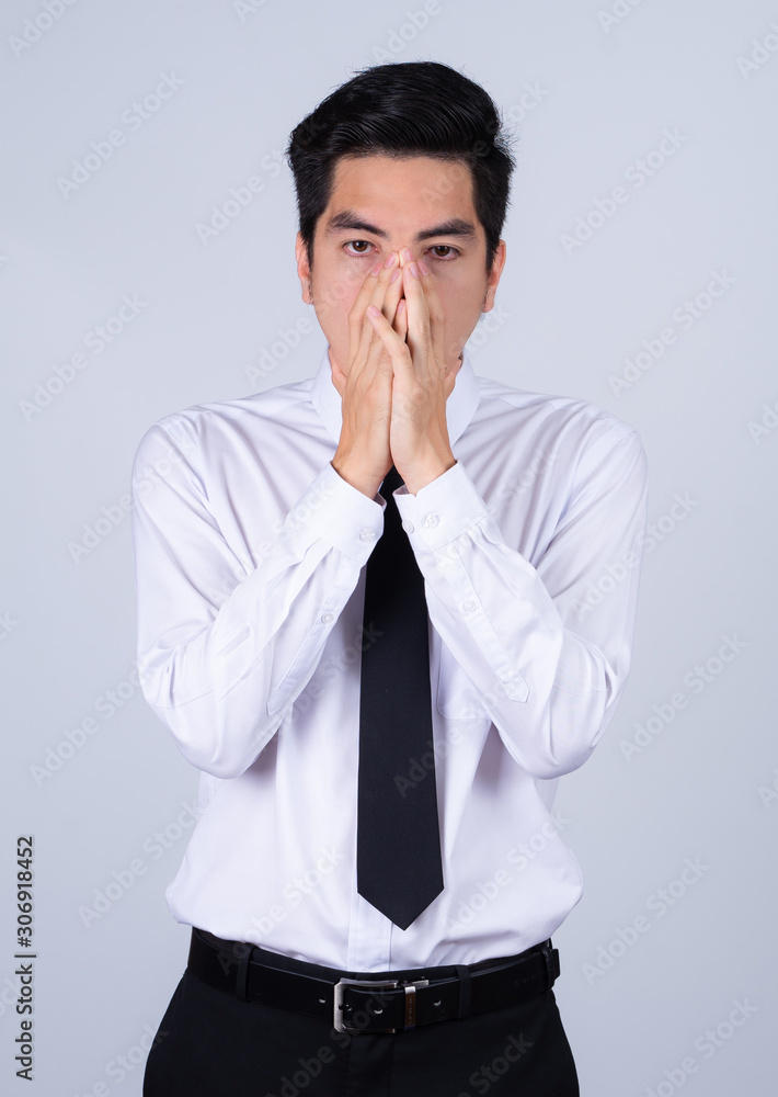 Portrait handsome young asian .businessman wearing a white shirt excitement or celebrating his victory sign isolated on grey background in studio. Asian man people. business success concept. Portrait handsome young asian .businessman wearing a white shirt excitement or celebrating his victory sign isolated on grey background in studio. Asian man people. business success concept.