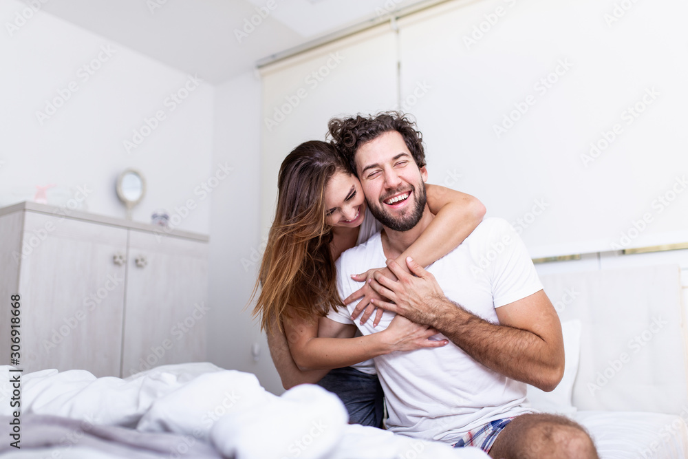 Woman embracing her partner in bed,