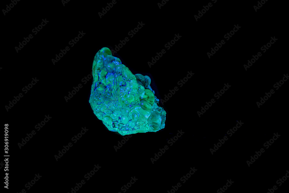 macro mineral stone opal under ultraviolet light on a black background macro mineral stone opal under ultraviolet light on a black background