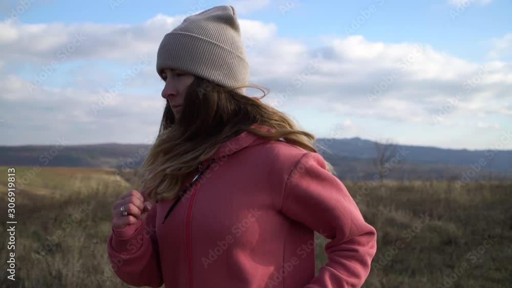 Young beautiful girl on a morning jog. Wind blows her hair. A great morning for a workout Young beautiful girl on a morning jog. Wind blows her hair. A great morning for a workout