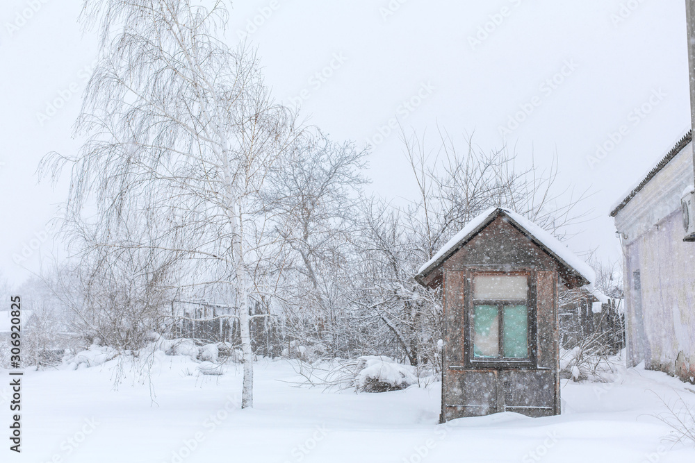 An old gatehouse in the middle of a snowy courtyard. near the warehouse An old gatehouse in the middle of a snowy courtyard. near the warehouse