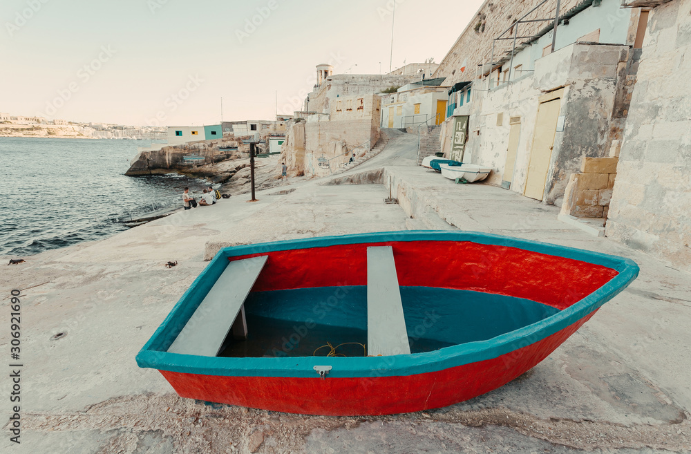 Fototapeta premium Colorful fishermen boats on land of Valletta city, Malta. Mediterranean landscape