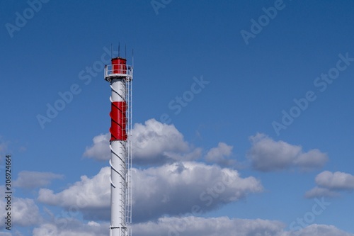 White with red chimney on a background of blue sky.