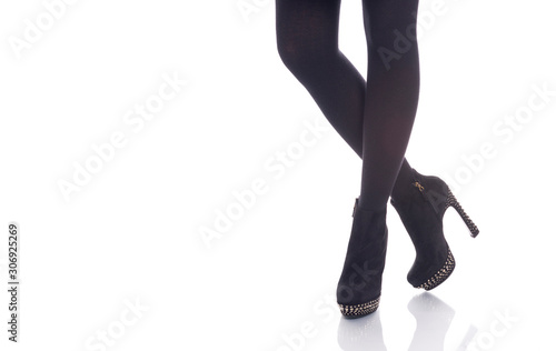girls legs in black stockings and suede boots