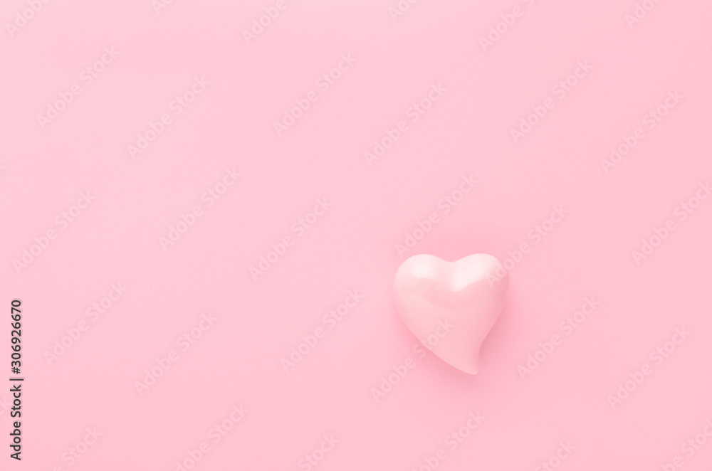pastel pink background with a heart with copy space