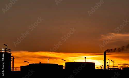 Gas turbine electrical power plant. Energy for support factory in industrial estate. Natural gas tank. Small gas power plant. Power plant using natural gas for fuel. Green energy. Dramatic sunset sky. photo