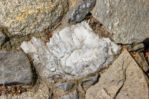 Closeup of an old pavement cobbled with natural rocks photo