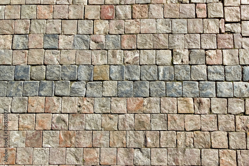 An old stoneblock pavement cobbled with square stone blocks