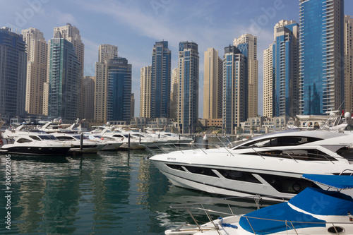 view from the pier of Dubai marina with its boats and skyscrapers © greta gabaglio