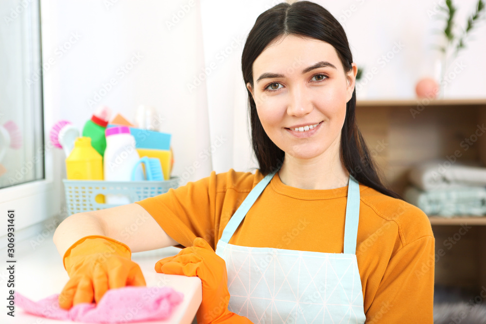 Young housewife is doing house cleaning.