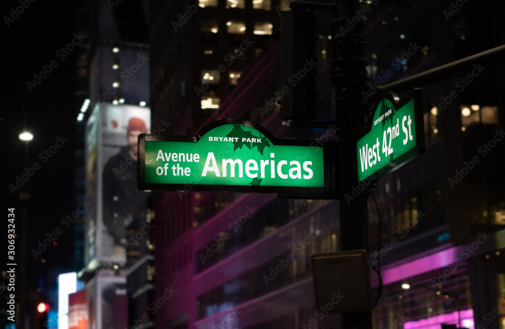 Avenue of the Americas and 42nd st. corner street sign in Bryant Park, New York City.
