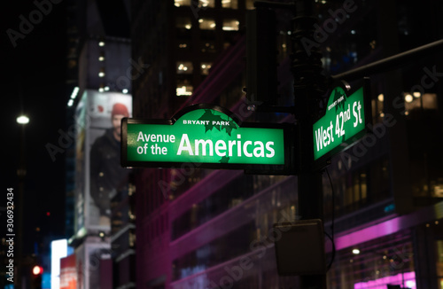Avenue of the Americas and 42nd st. corner street sign in Bryant Park, New York City.