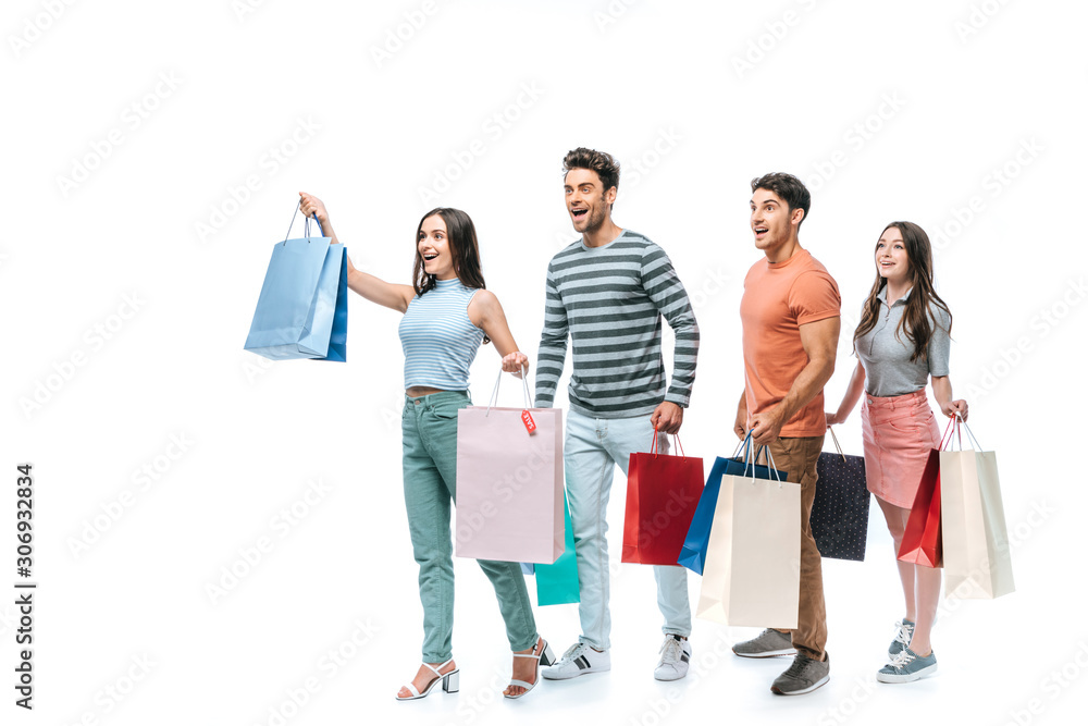 excited friends walking with shopping bags together, isolated on white excited friends walking with shopping bags together, isolated on white