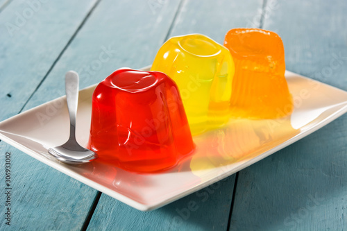 Colorful jelly on a plate on blue wooden background