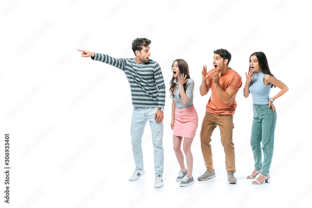 Obraz premium shocked man pointing and showing something to excited friends, isolated on white