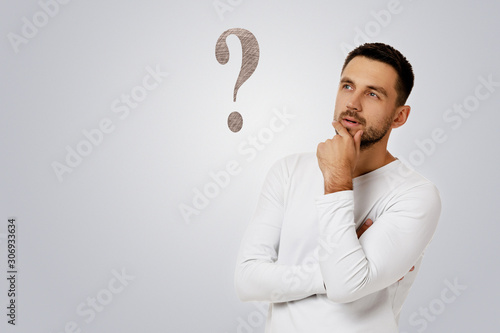 portrait of doubtful bearded man in casual white shirt asking questions isolated on white background. photo