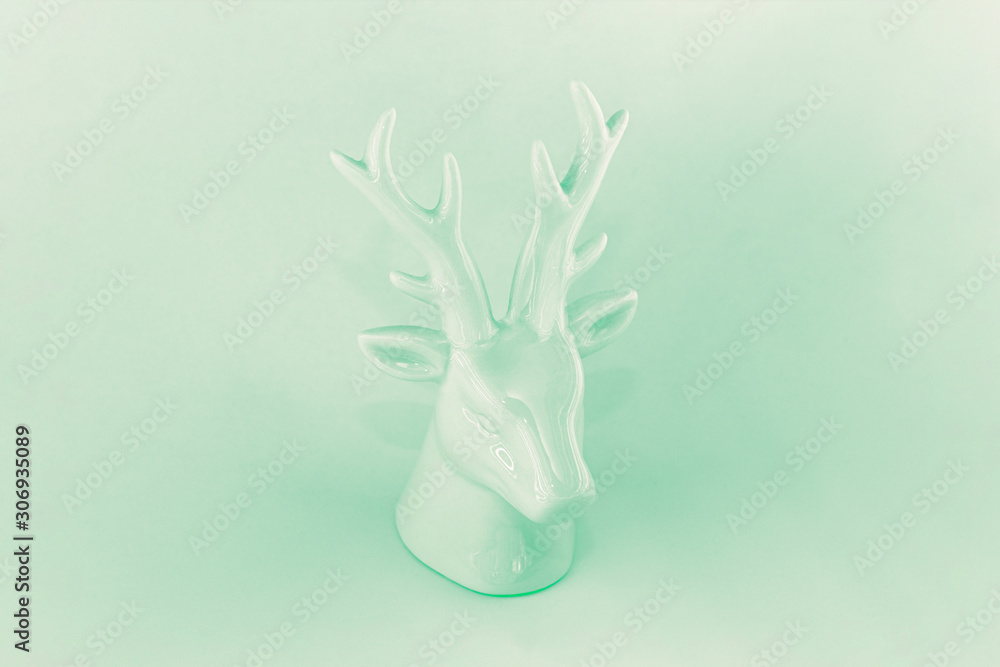 Sculpture Christmas deer in monochrome neo mint 2020 trend color. The concept of a winter vacation, minimalism, abstraction Sculpture Christmas deer in monochrome neo mint 2020 trend color. The concept of a winter vacation, minimalism, abstraction