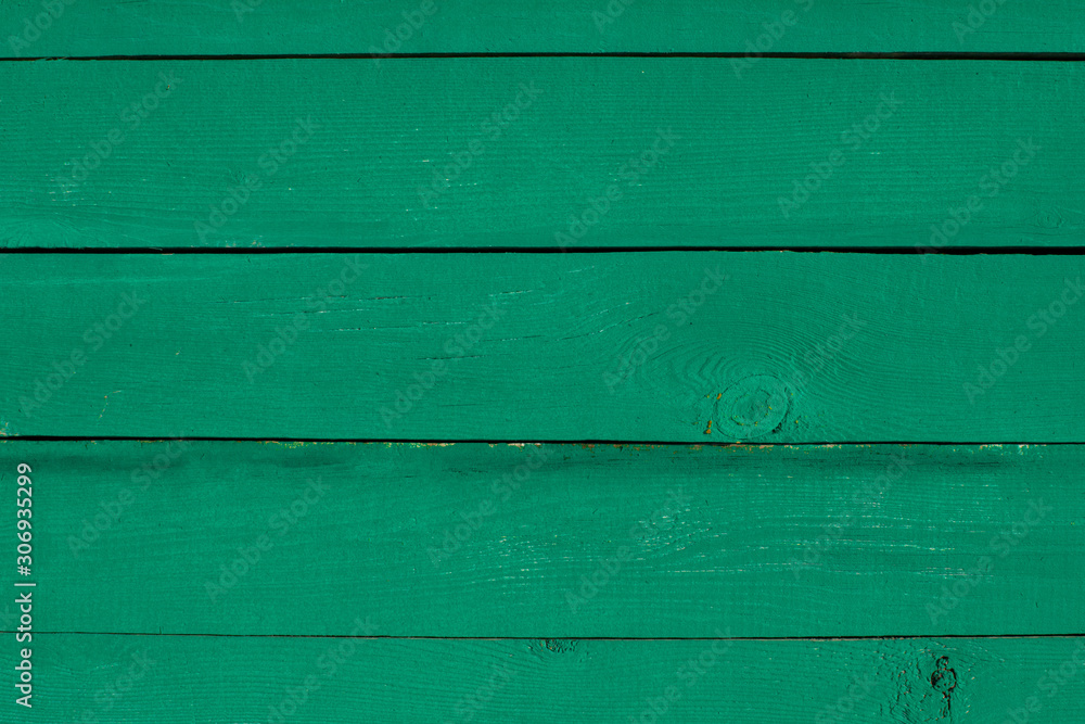 Fototapeta premium Colorful emerald painted wooden background. Vintage timber texture. Aged fence planks.