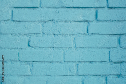 Pastel blue brick wall surface close-up with colorful grunge texture. Abstract modern background.