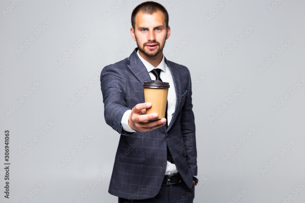 Young businessman offers a cup of coffee isolated on white background Young businessman offers a cup of coffee isolated on white background