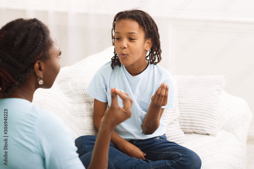 Black mother and daughter showing italian hand gesture Black mother and daughter showing italian hand gesture