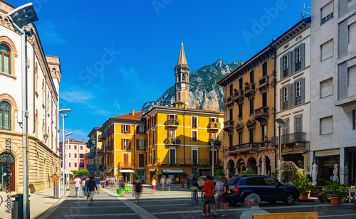 Lecco street with bell-tower of Basilica photo