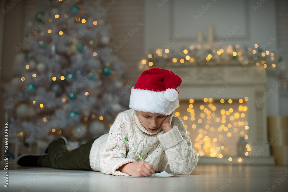 the child writes a letter with wishes for the new year. the child writes a letter with wishes for the new year.