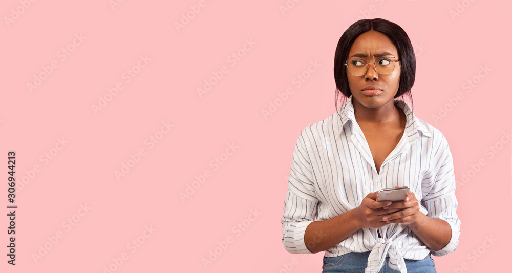 Pensive Black Girl Holding Smartphone Standing Over Pink Background, Panorama Pensive Black Girl Holding Smartphone Standing Over Pink Background, Panorama