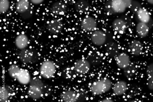 Texture of white snow blurry bokeh isolated black background. falling snow overlay. star sky. Black spots on white background  white drops and spots