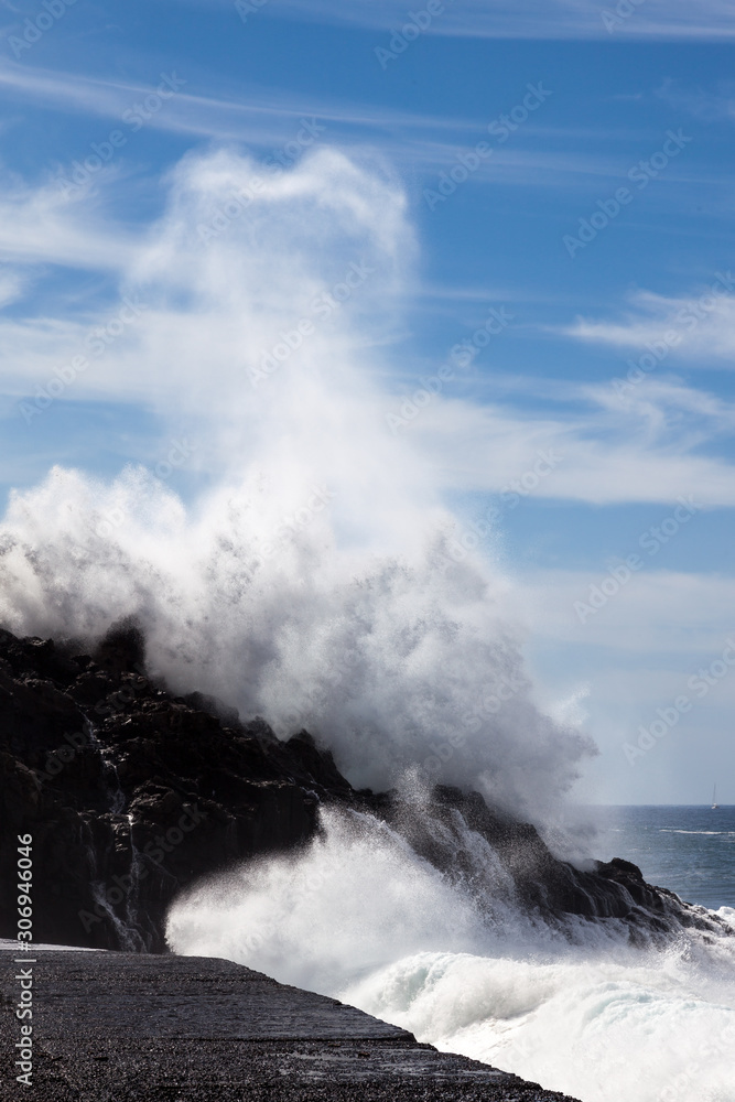 Massive wave hitting the rocky shore in Tenerife