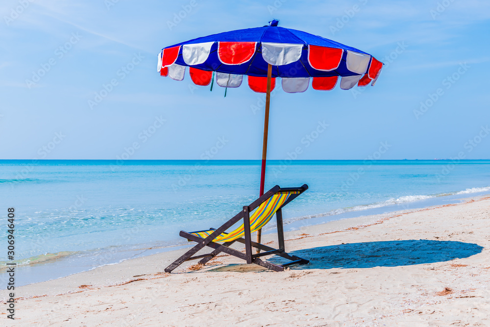 Beach chair and sun umbrella on coast in outdoors