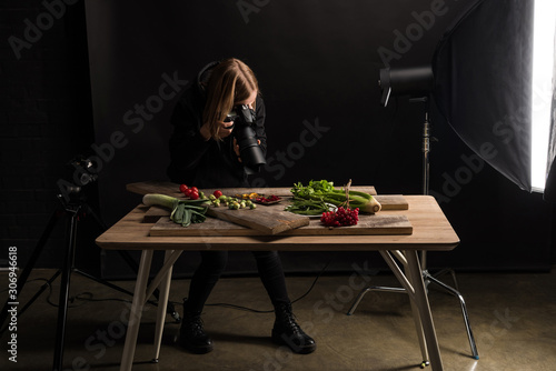 professional photographer making food composition for commercial photography and taking photo on digital camera