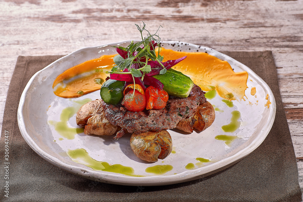 restaurant dish on white and gray plates, on a table restaurant dish on white and gray plates, on a table