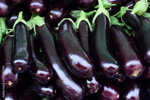 Pile of ripe fresh eggplants, close up.