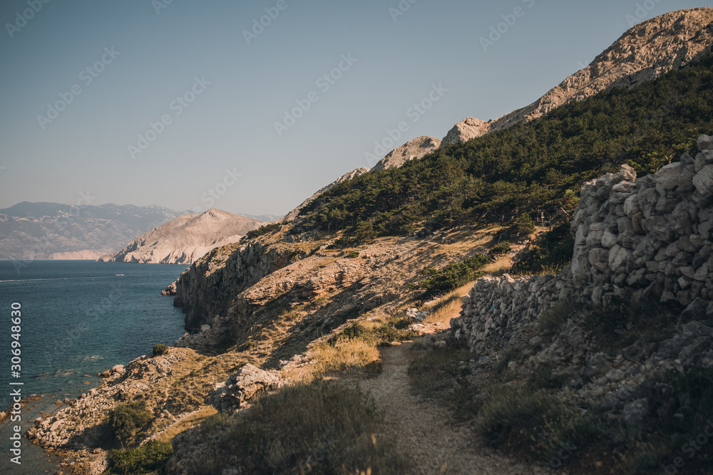 Adriatic Sea coastline. Rocky shore with turquoise sea water. Amazing summer seascape of Krk island