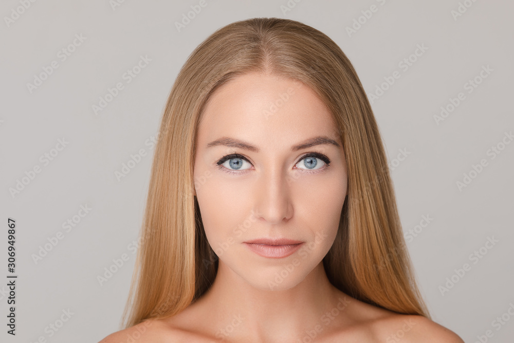 Medium close-up portrait of beautiful young European woman isolated at white studio background. Charming smiling naked female with long blonde hair looking at camera having positive emotion Medium close-up portrait of beautiful young European woman isolated at white studio background. Charming smiling naked female with long blonde hair looking at camera having positive emotion