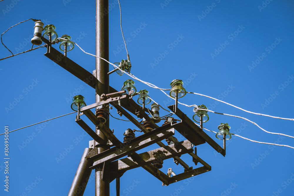 An iron pole with wires through which current flows to the houses. An iron pole with wires through which current flows to the houses.