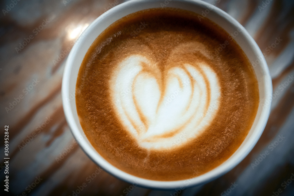 Fototapeta top view fresh coffee with latte art heart on a wooden background with dark vignette