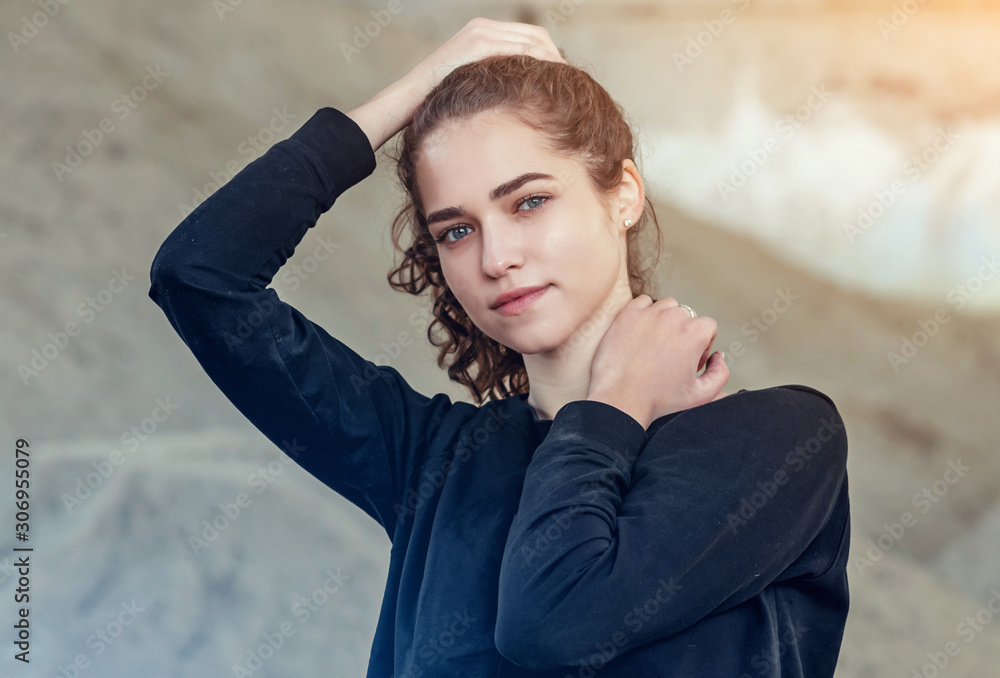 Portrait of girl with curly hair, raises hair with her hands on Portrait of girl with curly hair, raises hair with her hands on