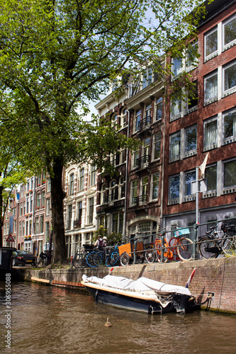 View of canal, trees, historical and traditional buildings showi photo