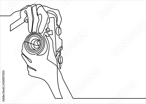 Vector Illustration of Hand Holding a Digital Camera- continuous line drawing