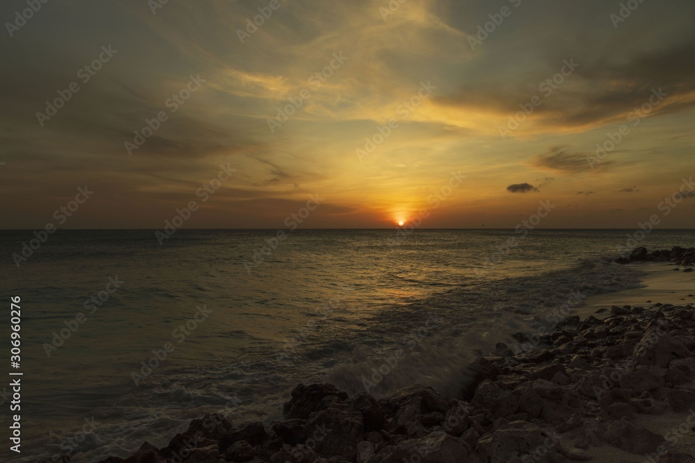 Gorgeous colorful view of sunset on Aruba. Beautiful nature landscape. Rocky coast of Atlanta, Caribbean.	